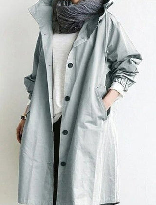 Women's oversized water-resistant trench coat by Christine Brewer featuring a button-front design and classic trench style.