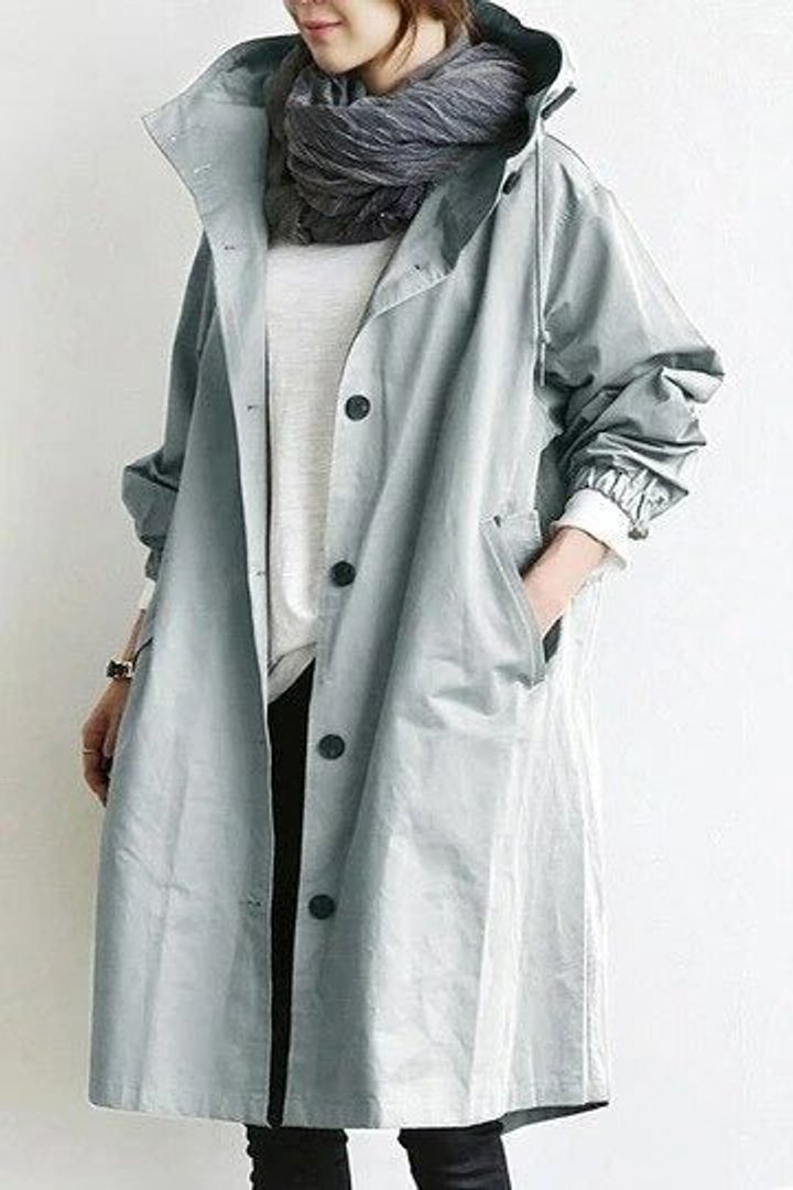 Women's oversized water-resistant trench coat by Christine Brewer featuring a button-front design and classic trench style.