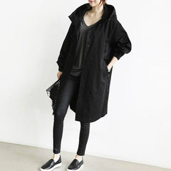 Women's oversized water-resistant trench coat by Christine Brewer with button-front design and classic trench style.