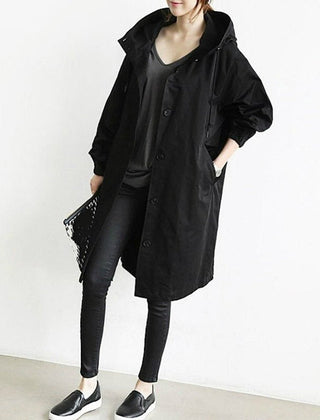 Women's oversized water-resistant trench coat by Christine Brewer with button-front design and classic trench style.