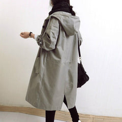 Women's oversized water-resistant trench coat by Christine Brewer with button-front design, shown in a stylish, relaxed fit.
