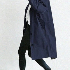 Women’s oversized water-resistant trench coat by Christine Brewer with button front, stylish and functional for rainy days.