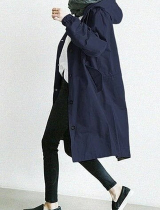 Women’s oversized water-resistant trench coat by Christine Brewer with button front, stylish and functional for rainy days.