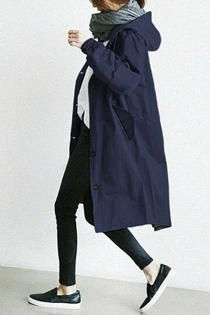 Women’s oversized water-resistant trench coat by Christine Brewer with button front, stylish and functional for rainy days.