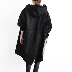 Women's oversized water-resistant trench coat with button-front closure by Christine Brewer, shown in a stylish, relaxed fit.