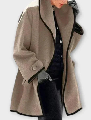 Black women's oversized wool-blend swing coat with contrast trim, designed by Christine Brewer.
