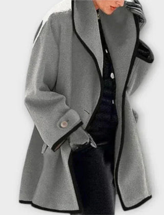 Black oversized wool-blend swing coat for women with contrast trim by Christine Brewer, shown on a model.
