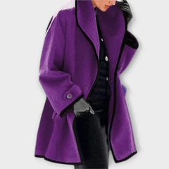 Women’s oversized black wool-blend swing coat with contrast trim by Christine Brewer, shown on a model.