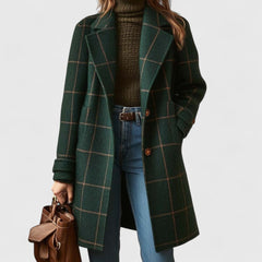 Women's plaid wool-blend longline coat with notch lapel, stylishly displayed on a hanger, showcasing its classic pattern and tailored fit.