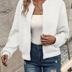 Women's quilted zip-up bomber jacket by Christine Brewer featuring textured, cropped design and quilted fabric.