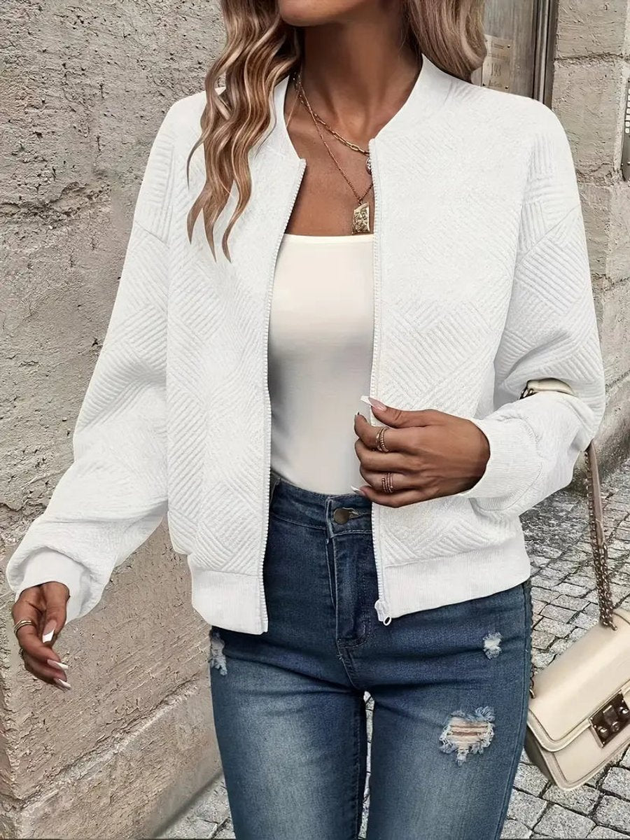 Women's quilted zip-up bomber jacket by Christine Brewer featuring textured, cropped design and quilted fabric.