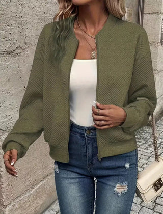 Women's quilted zip-up bomber jacket by Christine Brewer, textured cropped design with quilted detailing and modern style.