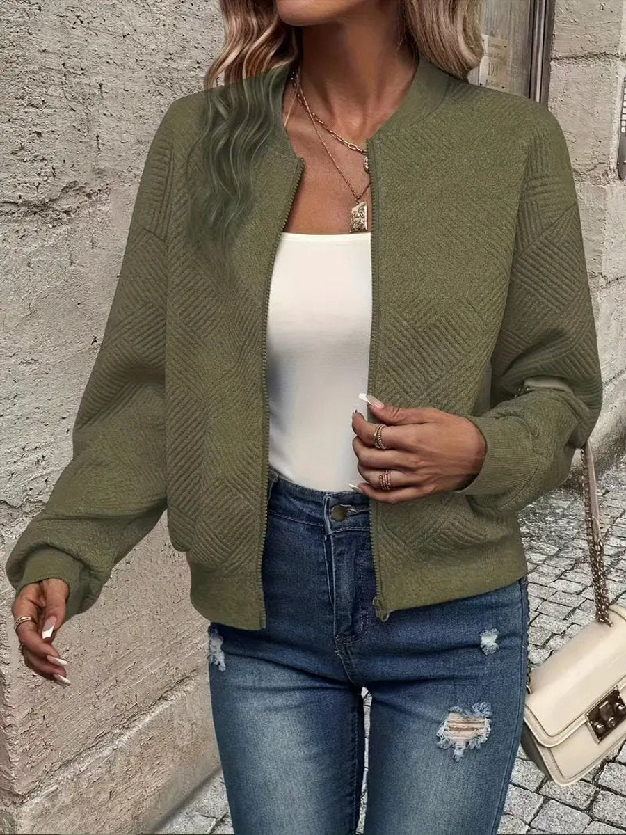 Women's quilted zip-up bomber jacket by Christine Brewer, textured cropped design with quilted detailing and modern style.