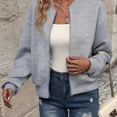 Textured quilted women's zip-up bomber jacket by Christine Brewer, cropped style, showcasing the stylish quilted exterior and modern fit.