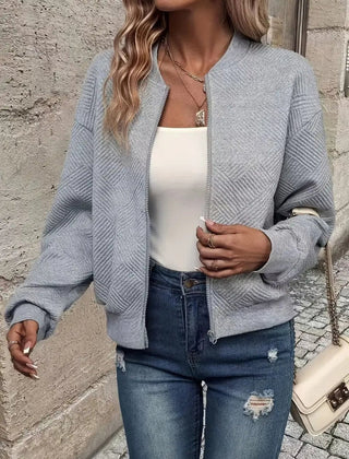 Textured quilted women's zip-up bomber jacket by Christine Brewer, cropped style, showcasing the stylish quilted exterior and modern fit.