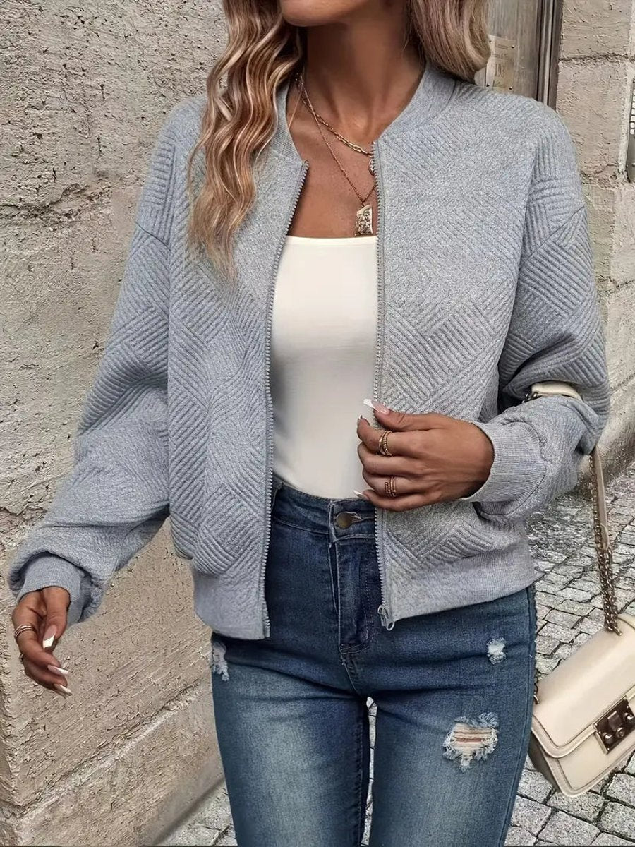 Textured quilted women's zip-up bomber jacket by Christine Brewer, cropped style, showcasing the stylish quilted exterior and modern fit.