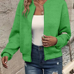 Women's quilted zip-up bomber jacket by Christine Brewer featuring textured, cropped design and stylish quilting details.