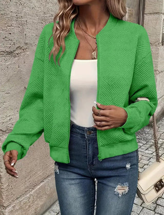 Women's quilted zip-up bomber jacket by Christine Brewer featuring textured, cropped design and stylish quilting details.
