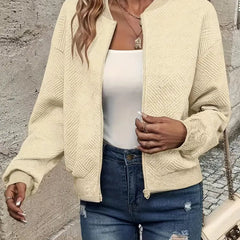 Women's quilted zip-up bomber jacket by Christine Brewer featuring textured, cropped design and modern styling.