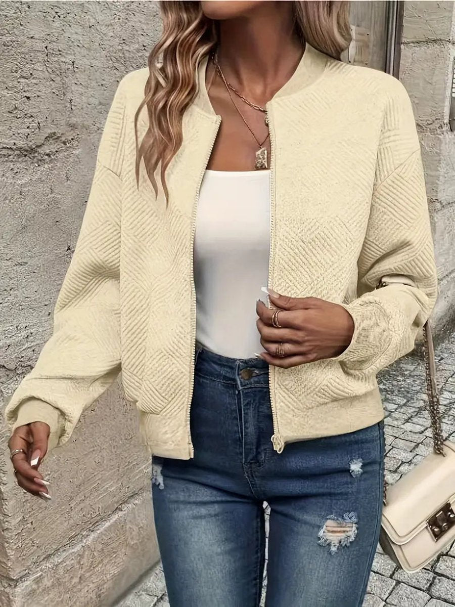 Women's quilted zip-up bomber jacket by Christine Brewer featuring textured, cropped design and modern styling.