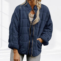 Women's relaxed-fit diamond quilted zip-up jacket by Christine Brewer, showing the casual jacket with front zipper and quilted texture.