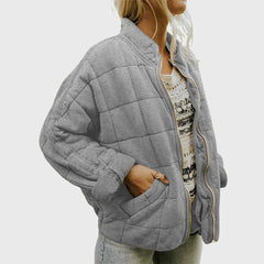 Women's relaxed-fit diamond quilted zip-up jacket by Christine Brewer, showcasing the casual, stylish design and cozy texture.