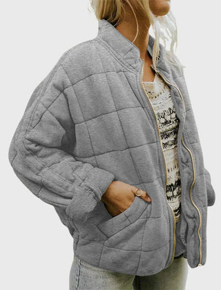 Women's relaxed-fit diamond quilted zip-up jacket by Christine Brewer, showcasing the casual, stylish design and cozy texture.
