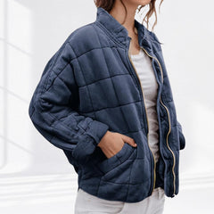 Women's relaxed-fit diamond quilted zip-up jacket by Christine Brewer, shown in a casual setting with front view.