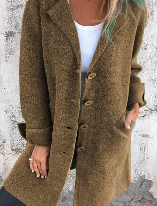 Women's relaxed-fit long button-front lapel coat by Christine Brewer, casual style, shown on a model with pockets and lapel collar.