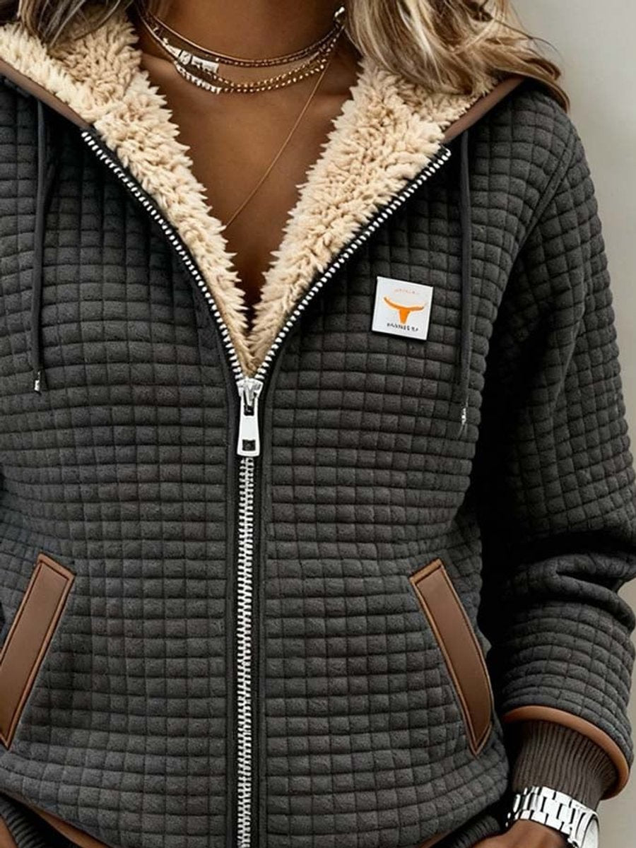 Women's Sherpa-lined quilted jacket with full-zip front, hood, and fleece material by Christine Brewer.