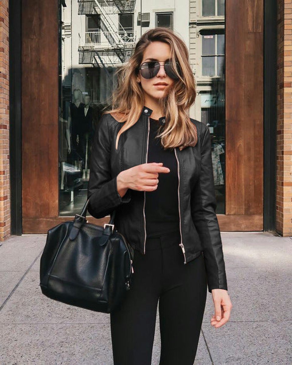 Women’s slim-fit zip-up faux leather jacket by Christine Brewer, shown in a stylish close-up of the jacket's front.