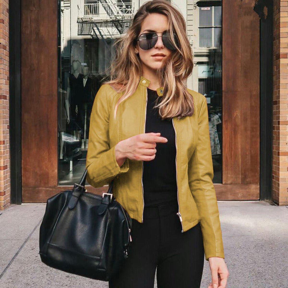 Sophie women's slim-fit zip-up faux leather jacket by Christine Brewer, shown in black, with a high collar and zipper front.