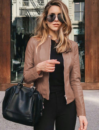 Women's slim-fit faux leather zip-up jacket by Christine Brewer, shown in a stylish, fitted design on a model.