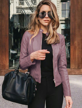 Women's slim-fit faux leather zip-up jacket by Christine Brewer, shown on a model with a stylish, fitted silhouette.
