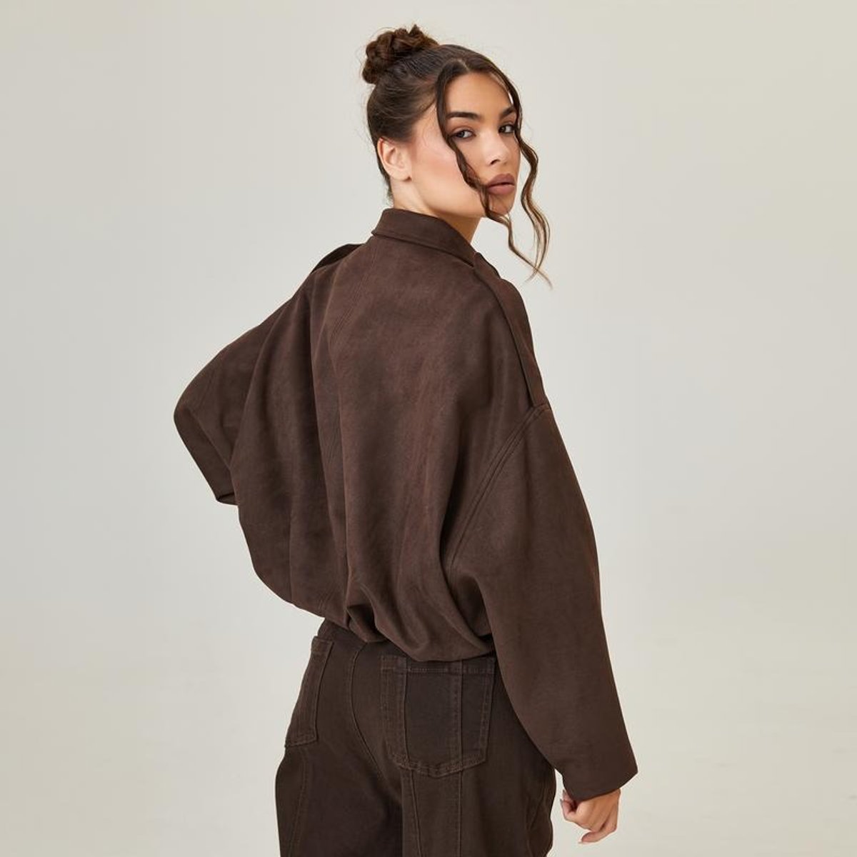 Vintage-inspired women's faux suede oversized bomber jacket by Christine Brewer, shown in a stylish, relaxed fit.