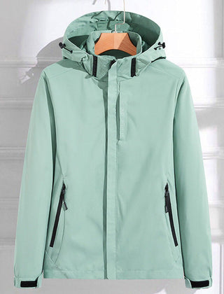 Women's waterproof hooded rain jacket by Christine Brewer featuring adjustable fit and durable waterproof material.