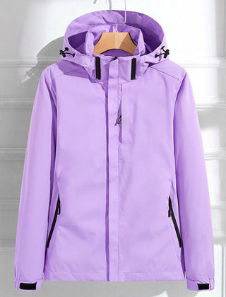 Women's waterproof hooded rain jacket by Christine Brewer with adjustable fit, designed for outdoor rain protection.
