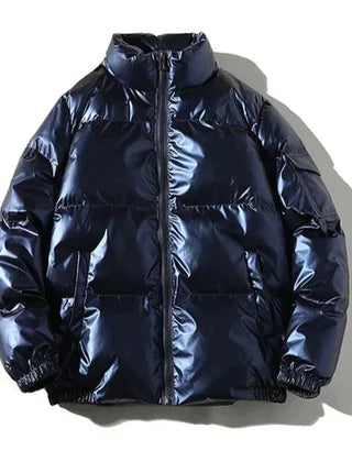 Blue Xenia windproof metallic puffer jacket for women by Christine Brewer, featuring a cozy, insulated puffer design.