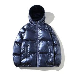 Xenia windproof metallic blue puffer jacket for women by Christine Brewer, featuring a hood and cozy insulation.